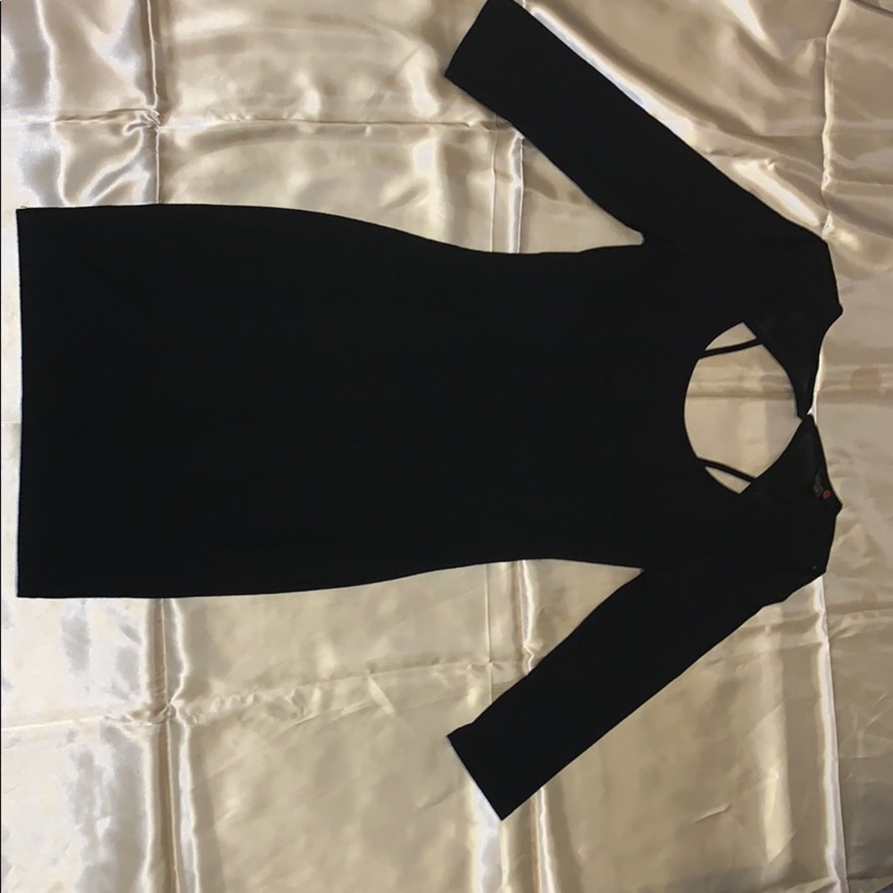 Mini black dress with open back.